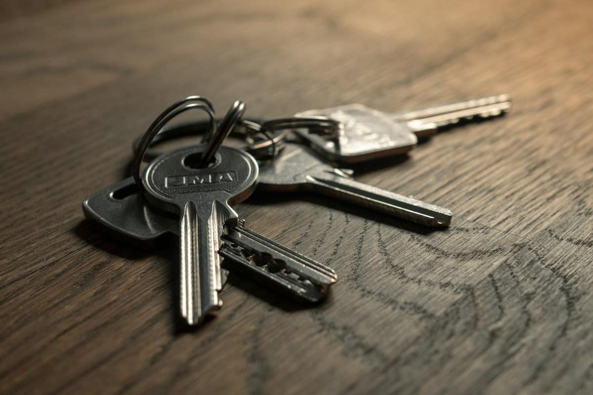 Keys on a wooden table – capital gains tax planning for property investors before a sale