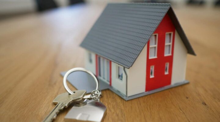 Model house on a desk – capital gains tax planning for property investors