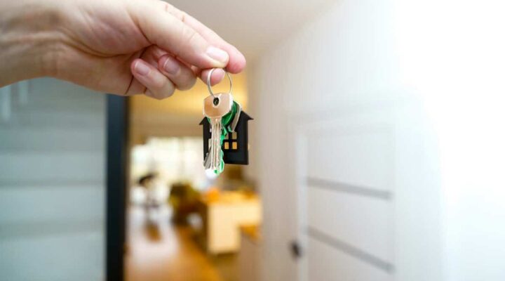 Keys to an inherited home held at the front door