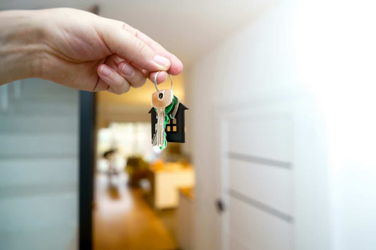 Keys to an inherited home held at the front door