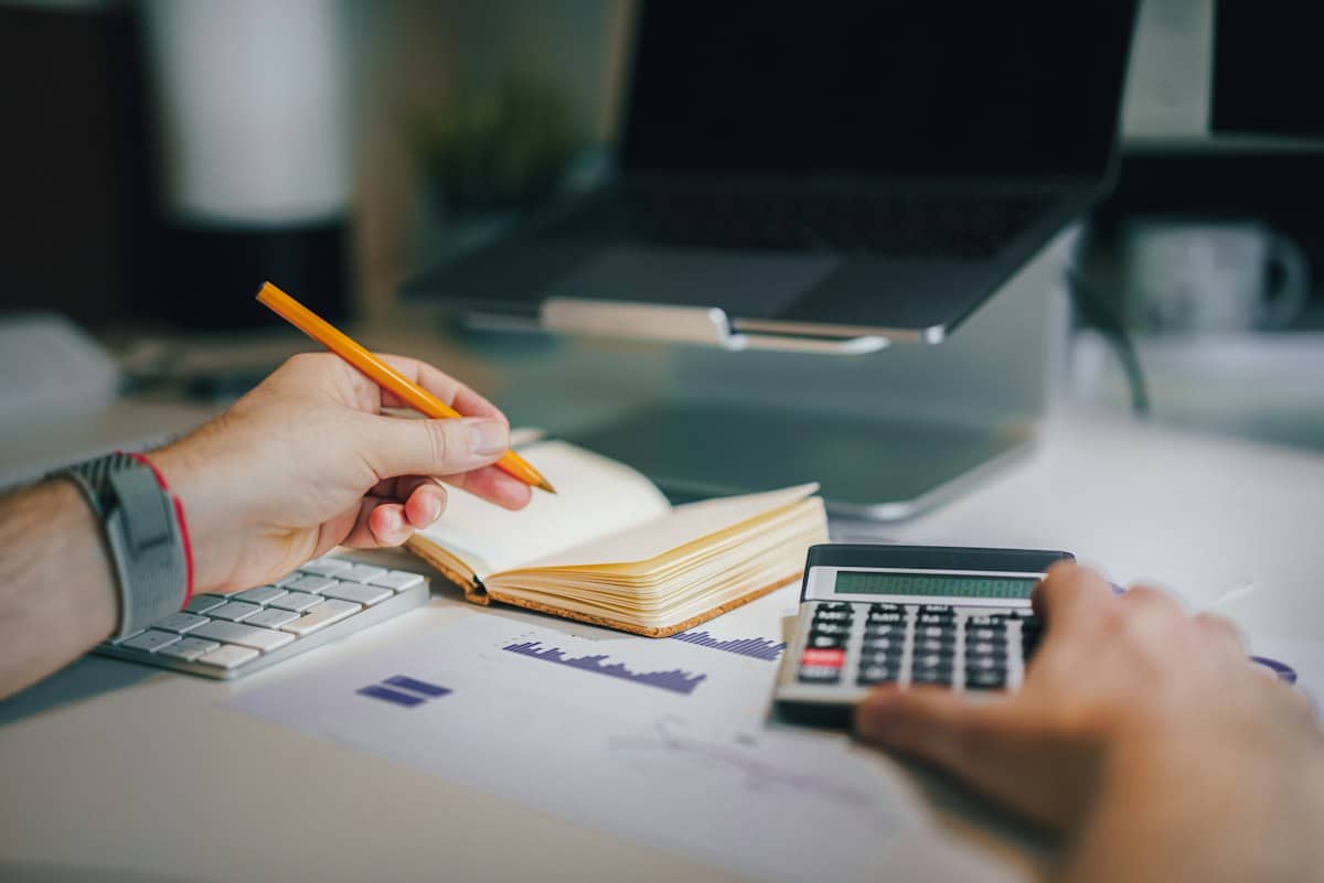 Rental property capital gains tax calculation with a calculator at a desk